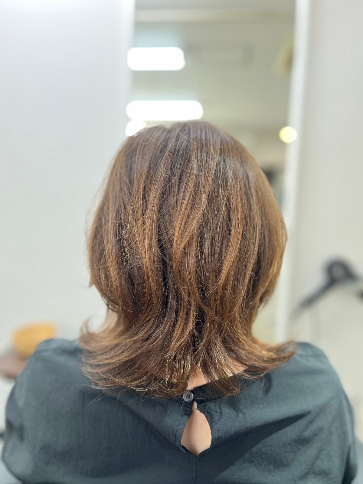 湿気で膨らむ癖毛を自然な縮毛矯正でまとめる